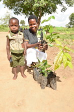 a mother and son receiving seedlings