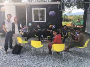 Guitar class in fron of our Classroom container