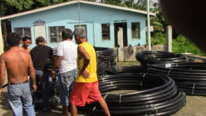 community menfolks helping out with the pipes