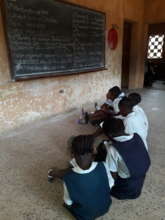 Students sitting on the ground at school