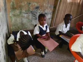 Students with chairs but no desks