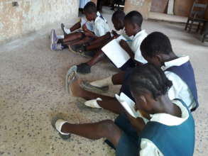 Kids sitting on floor in classroom