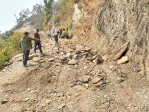 Locals clear the road for construction vehicles