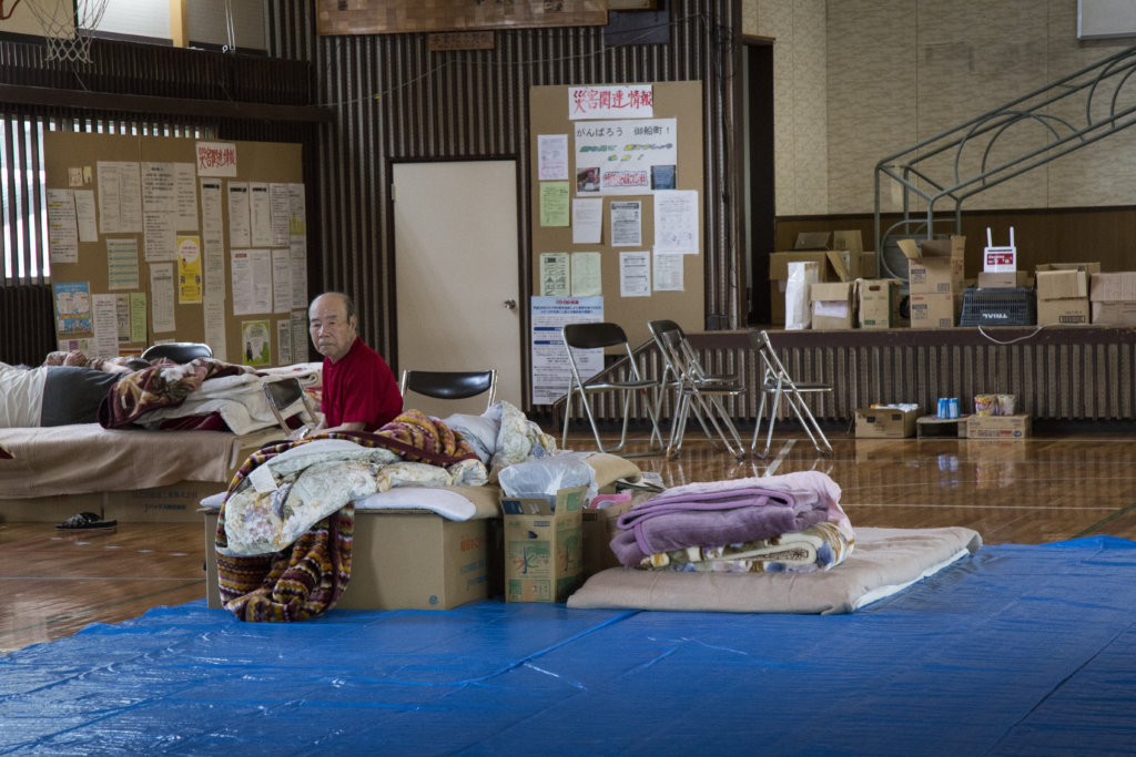 A man with his belongings in the shelter
