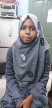 Zainab uses her smartphone to access her education