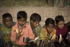 Boys enjoy milk and bananas at Wings