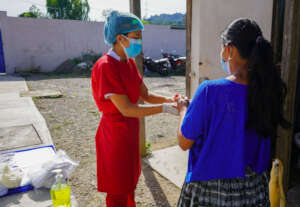 A WINGS nurse working with a patient