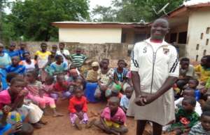 Ntiibe making contribution in a community meeting