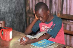 Boy studying at night with solar light