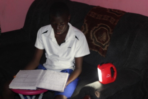 Emmanuel studying with his solar light