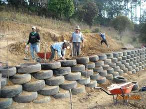 Retaining wall made out of old tires and plastic bottles