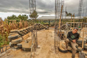 Roberto in front of tire house for Alex, Comalapa
