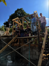 Volunteers contribute to the compost latrine!