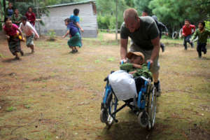 Alex helping our student, Miguel, with the race!