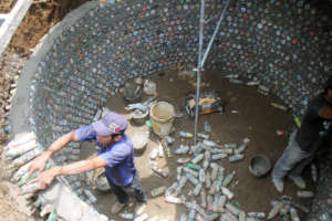 Students building with eco-bricks