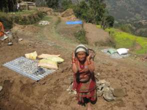 Elderly woman works to build her new home
