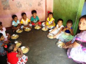 A donor giving food to the children