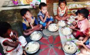Children eating egg rice in the centre