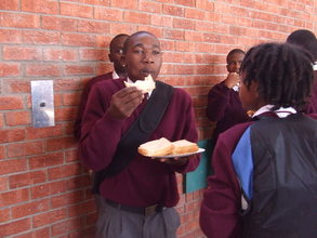 Mfundo enjoying a sandwiche provided by donor funds