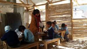 Students study in a hut made of bamboo and plastic