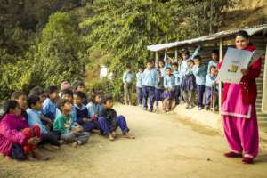 A teacher practices reading aloud to students