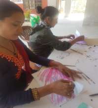 Sarita adds an illustration to a book about bees.