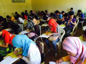 male and female students taking final exams at MSU