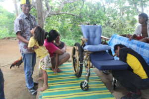 Exicing father receiving wheelchair for his son
