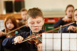 Thomas learning to play the violin