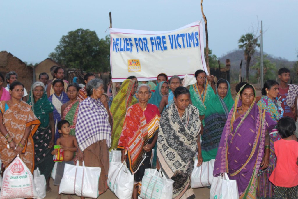 Providing Food packets to the fire victims