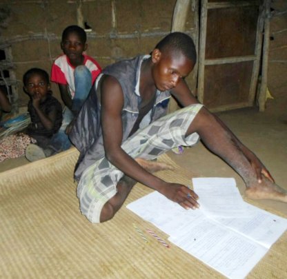 Ali completing his homework using solar lantern