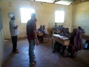 Mr. Eddy Adison addressing Bahati Primary students
