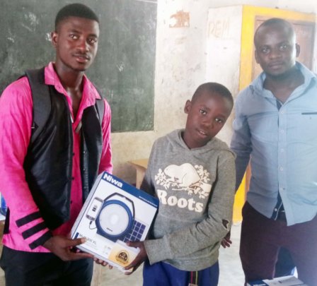 Bakari receiving his Solar Lantern