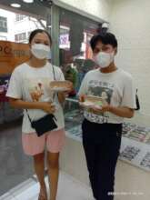 Two students show off the glasses they received.