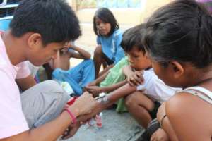The youth teach street kids to treat wounds