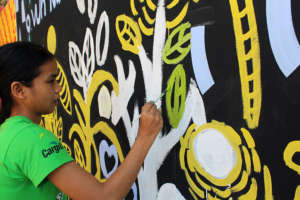 Savun painting a mural she designed