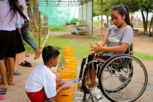 Malis teaches a student proper hand washing steps