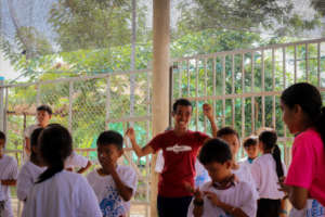 Sok leading a dance workshop at a local schools
