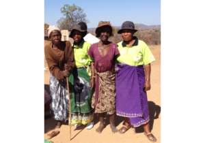 Community caregivers stand with two patients