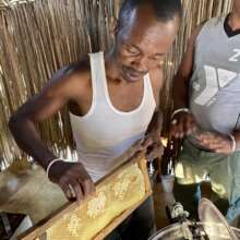 A local beekeeper uses a honey extractor.