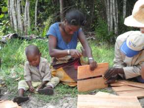 A beekeeper assembles a new hive