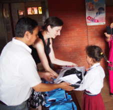 Handing Alina her new school supplies