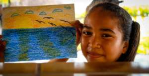 Diana showing off her work from art class