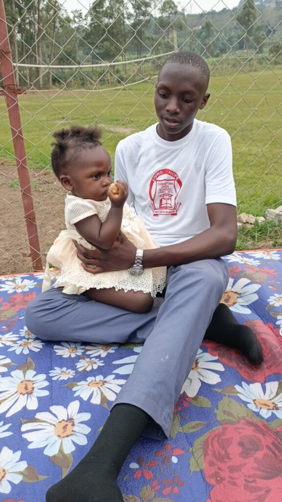 Asher helping care for his little sister