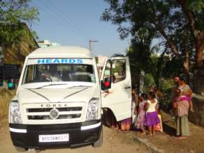 Children coming by van from far away distance
