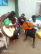 Girls learning life skills of Guitar playing