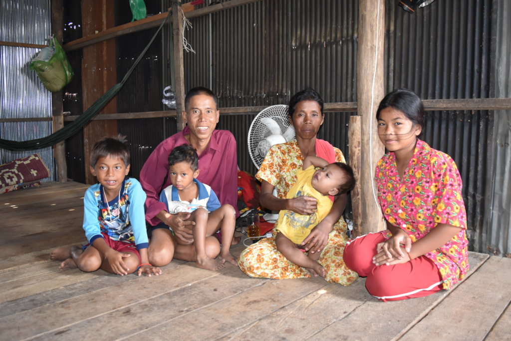 Koerng and his family in their one-room home