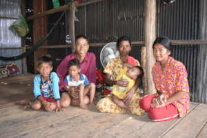 Koerng and his family in their one-room home