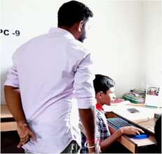 Mainul* engrossed in Computer with the Teacher