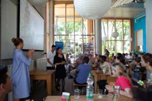 A refugee woman presents to an educational group.